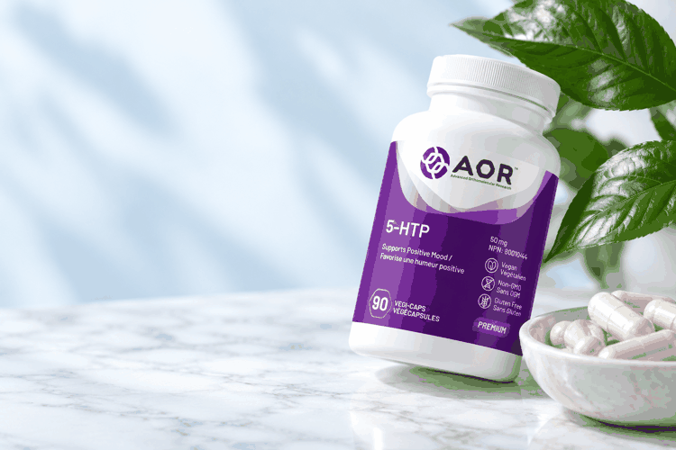 AOR 5-HTP bottle beside a marble bowl of capsules and green leaves